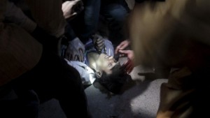 An injured man lies on the ground while being tended to after an explosion in Pakistan on Sunday. (Reuters)