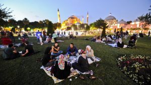 Turkish people break their fasting on June 28, 2014 at the Blue Mosque square during the first day of the holy month of Ramadan in Istanbul. During Ramadan, Muslim believers abstain from eating, drinking, smoking and having sex from dawn until sunset. Ramadan is sacred to Muslims because it is during that month that tradition says the Koran was revealed to the Prophet Mohammed. The fast is one of the five main religious obligations under Islam. AFP PHOTO/OZAN KOSE